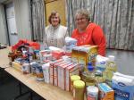 Our 2015 Advent party showing the food pantry donations with two members (Jeannette Brochu and Mary Ainsworth) who are on the board for the food pantry.