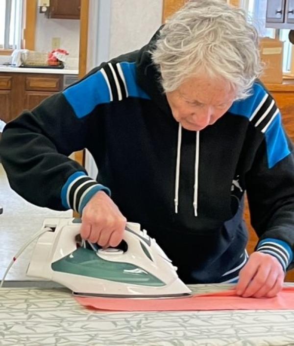 Nan Perron takes the job of pressing fabric very seriously.